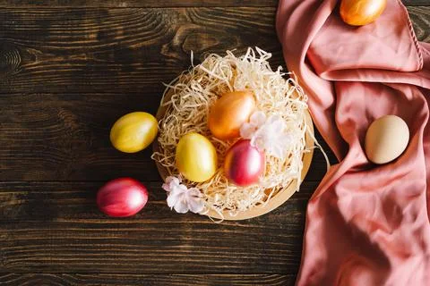 Multicolored Easter eggs on a wooden background. Stock Photos