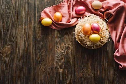 Multicolored Easter eggs on a wooden background. Stock Photos
