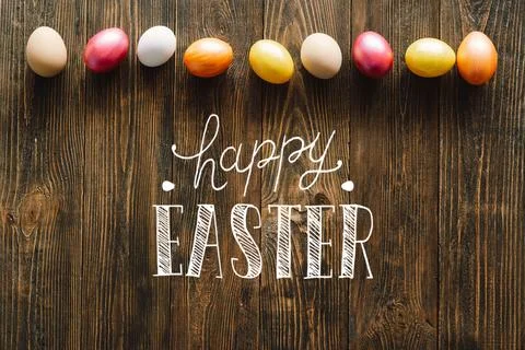 Multicolored Easter eggs on a wooden background. Stock Photos