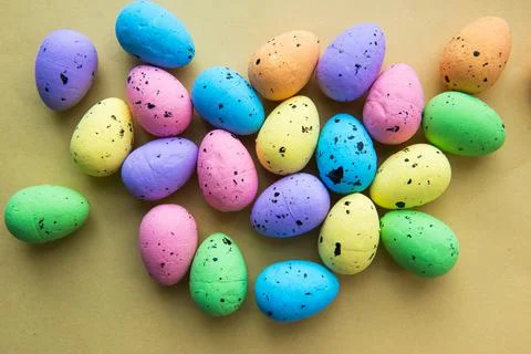 Multicolored Easter eggs on a yellow background. Decorative easter eggs. Happ Stock Photos