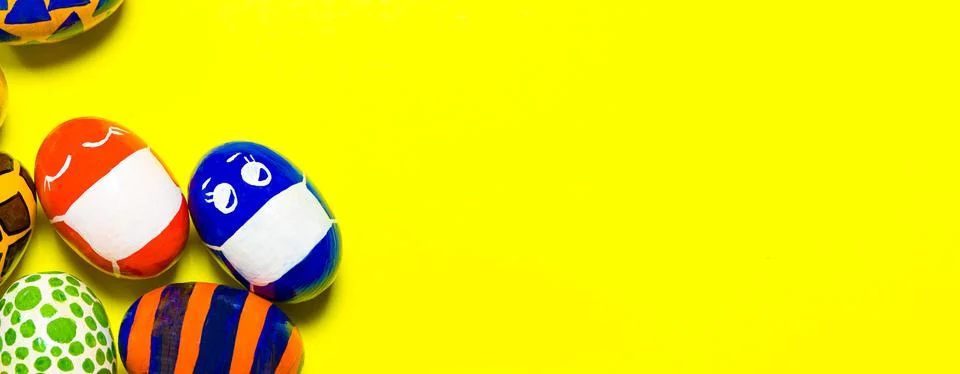 Multicolored Easter eggs on a yellow background. Stock Photos