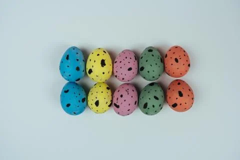 Multicolored Easter quail eggs isolated on white background. Happy Easter and Stock Photos
