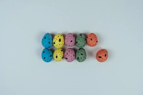 Multicolored Easter quail eggs isolated on pink background. Happy Easter and Stock Photos