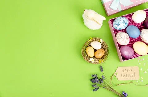 Multicolored eggs in open gift box. Concept of the Happy Easter holiday, gree Stock Photos