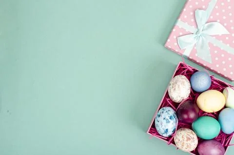 Multicolored eggs in open gift box. Concept of the Happy Easter holiday, gr.. Stock Photos