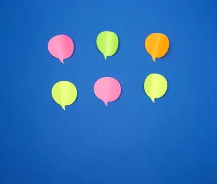 Multicolored empty paper stickers in the form of clouds on a blue background 库存照片