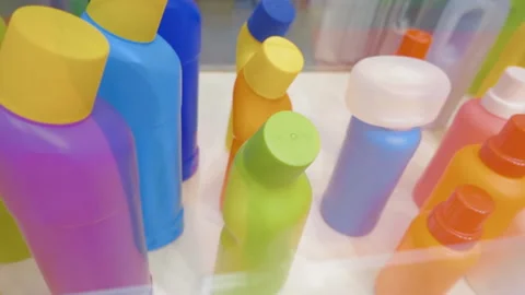 Multicolored empty plastic bottles and containers for storing liquid products  Stock Footage 98230817