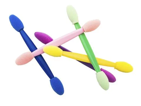 Multicolored eyeshadow applicators over the white background Stock Photos