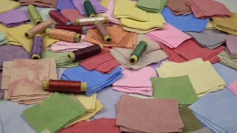 Multicolored fabrics  and spools of colored sewing lored sewing threads on it Stock Footage 262262022