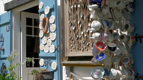 Multicolored faience and porcelain cups and mugs on wall of cafe shop Stock Footage 255010036