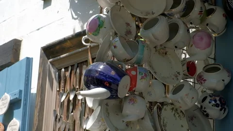 Multicolored faience and porcelain cups and mugs on wall of cafe shop Stock Footage 255010077