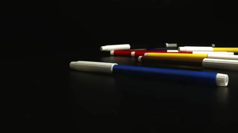 Multicolored felt-tip pens falling on the black surface. Homeschooling concept. Stock Footage 144516348
