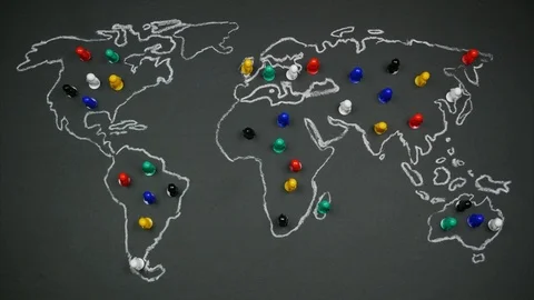 Multicolored figures of people on a world map drawing on blackboard Stock Footage 115662375