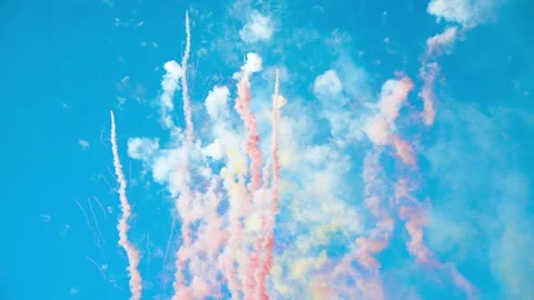 Multicolored fireworks exploding in the bright clear blue sky in the daytime Video stock 142066761