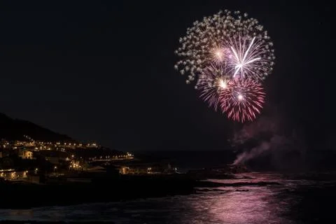 Multicolored fireworks exploding in the sky at night Stock Photos