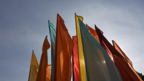 Multicolored flags clap in the wind. Ray of the sun. Stock Footage 97812527