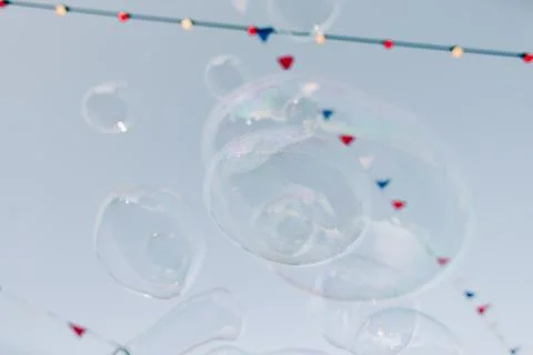 Multicolored flags flutter in the wind over a street fair Stock Photos