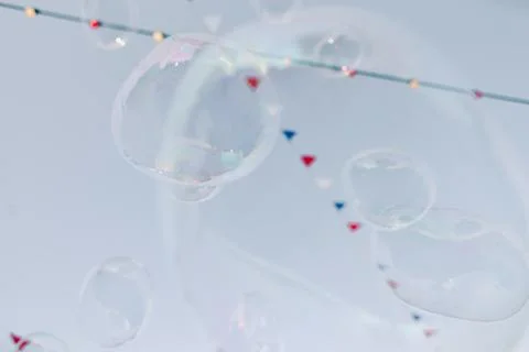 Multicolored flags flutter in the wind over a street fair Stock Photos