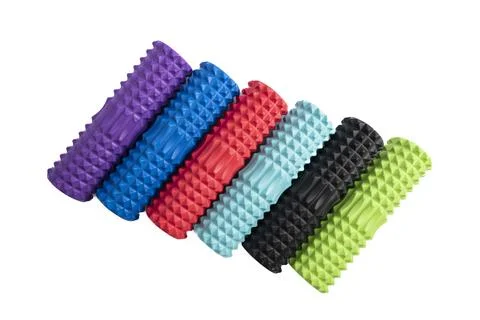 Multicolored foam rollers on white background. Gym fitness equipment. Self bo Стоковые фото