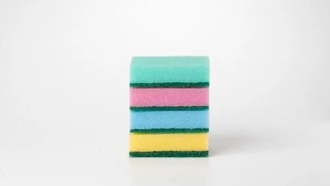 Multicolored four sponges folded into a flat stack on a white background Stock Photos