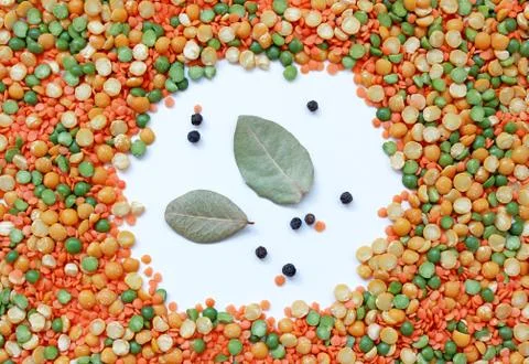 Multicolored frame of mixture of peas and lentils with bay leaf Stock Photos