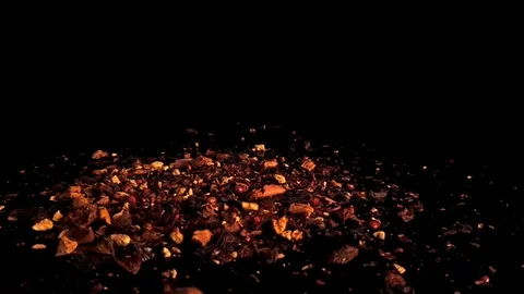 Multicolored fruit dry tea rotates on a dark turntable on a black background Stock Footage 125251529