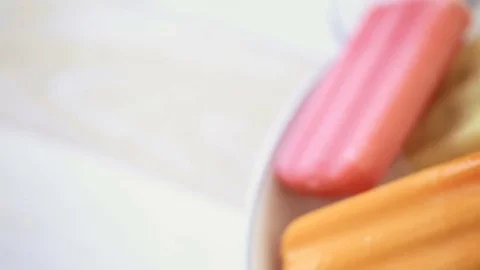 Multicolored fruit ice cream bars on metal tray with ice. Stock Footage