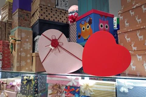 Multicolored gift boxes with bows in the mall. Paper boxes for decorating Chr Stock Photos