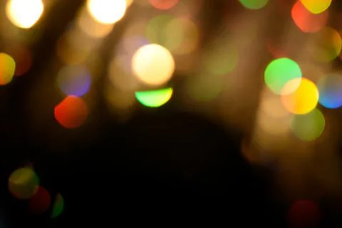 Multicolored glitter lights background. Blurry rainbow defocused circles. Stock Photos