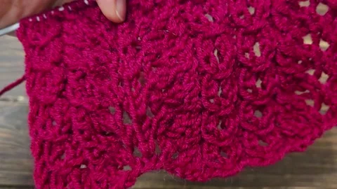 Multicolored hand-knitted fabric. Knitting and crochet lessons. Fashion Stock Footage 345023174