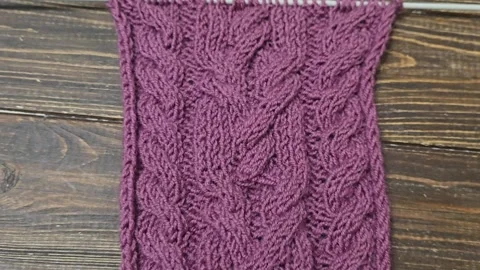 Multicolored hand-knitted fabric. Knitting and crochet lessons. Fashion Stock Footage 345023353