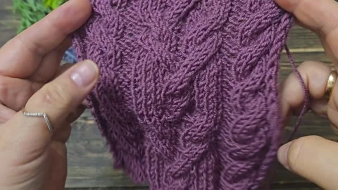 Multicolored hand-knitted fabric. Knitting and crochet lessons. Fashion Stock Footage 345023432