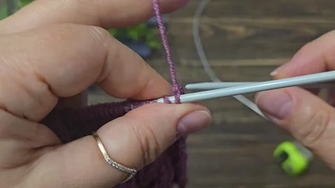 Multicolored hand-knitted fabric. Knitting and crochet lessons. Fashion Stock Footage 345023649