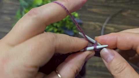 Multicolored hand-knitted fabric. Knitting and crochet lessons. Fashion Stock Footage 345023662