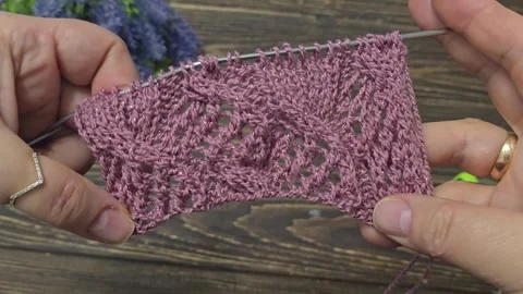 Multicolored hand-knitted fabric. Knitting and crochet lessons. Fashion Stock Footage 345023770