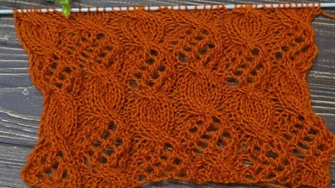 Multicolored hand-knitted fabric. Knitting and crochet lessons. Fashion Stock Footage 345023851