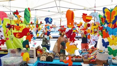 Multicolored hand made souvenirs and toys are sold at the street market in Stock Footage 75054926