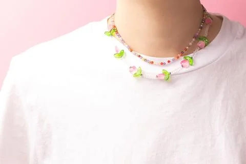 Multicolored handmade chains made from beads and natural stones. Stock Photos