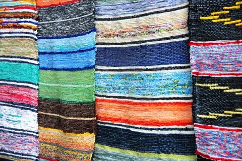 Multicolored handmade rugs. Stock Photos