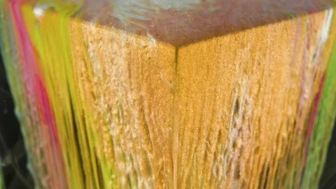 Multicolored ink paint slowly flows from the cube underwater Stock Footage 104154441