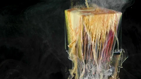 Multicolored ink paint slowly flows from the cube underwater Video stock 104171287