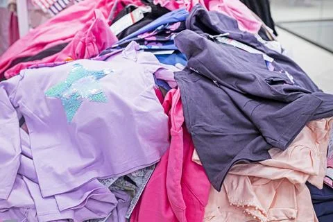 Multicolored items piled haphazardly on a table. Order and time Stock Photos