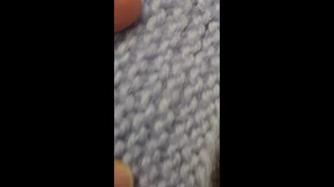 Multicolored knitted fabric, handmade. Knitting and crochet lessons. Fashion Stock Footage 340607994