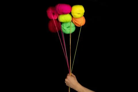 Multicolored knitting threads. balloons. in the hand of a man Stock Photos