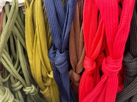 Multicolored laces of different sizes and shapes in the store Stock Photos