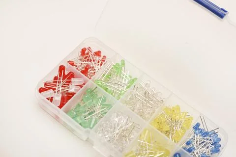 Multicolored LEDs in a plastic box on a white background. LED radio elements. Stock Photos