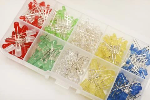 Multicolored LEDs in a plastic box on a white background. LED radio elements. Stock Photos