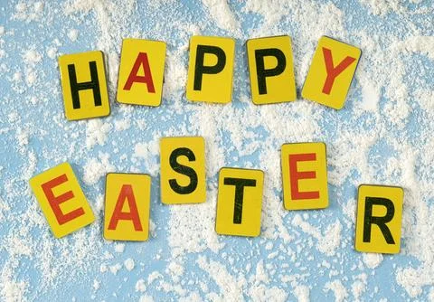 Multicolored letters arranged in the word "Easter" on a blue background wit.. 库存照片