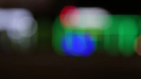 Multicolored light on a black background, bokeh effect. For layout on top of the Video stock 217376615