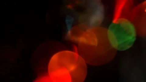 Multicolored light leaks on a black background with bokeh effect Stock Footage 166703155